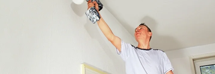 Person streicht eine Wand weiß